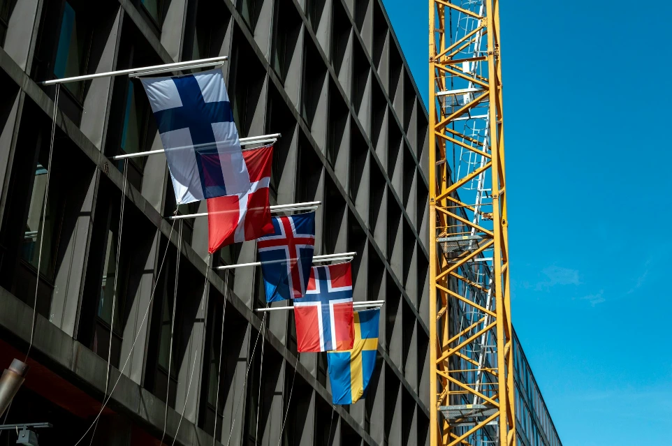 A tall building with a crane next to it